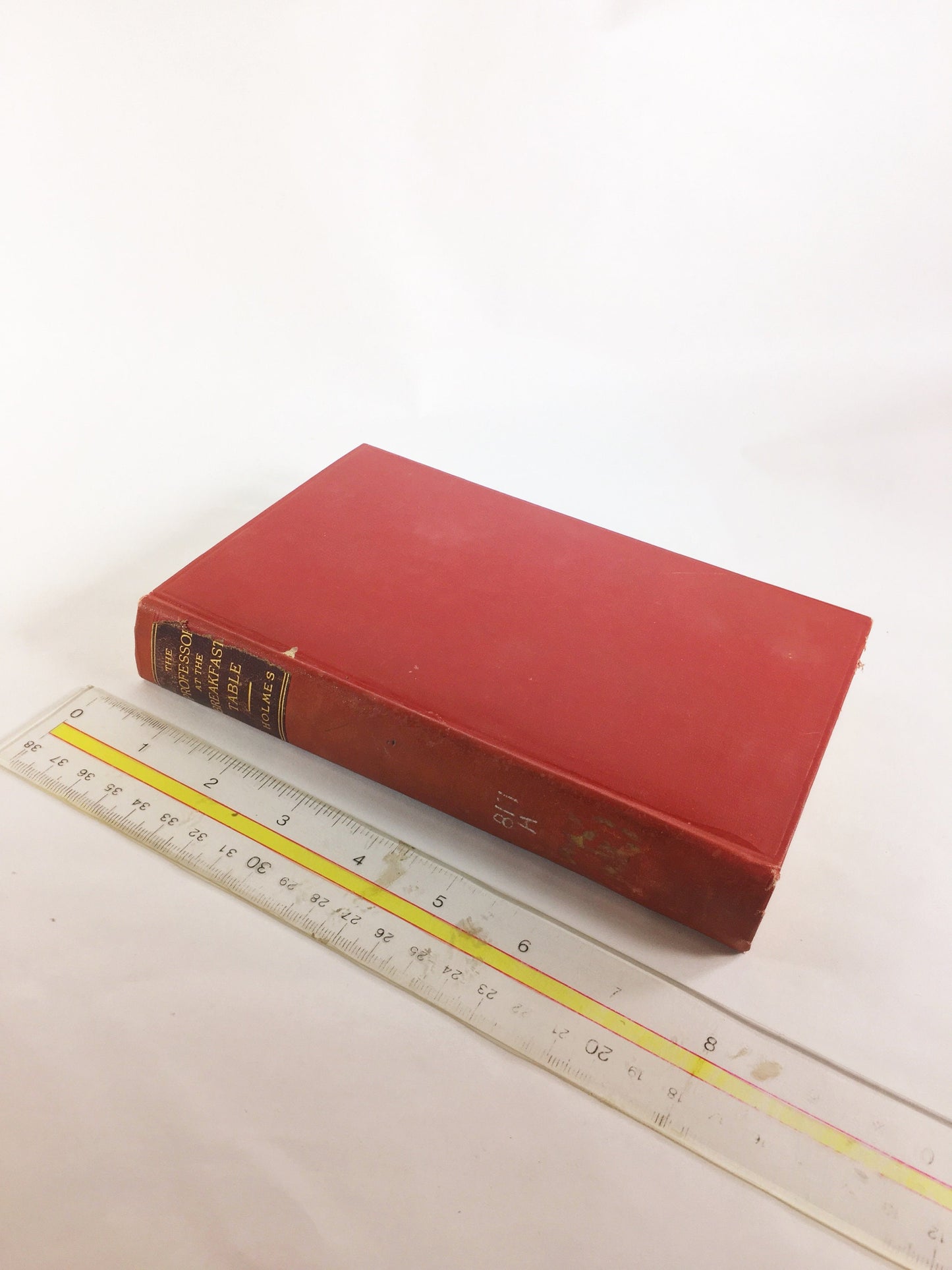 1892 Oliver Wendell Holmes The Autocrat Professor at the Breakfast Table. Vintage red book of a collection of essays. Decor prop staging