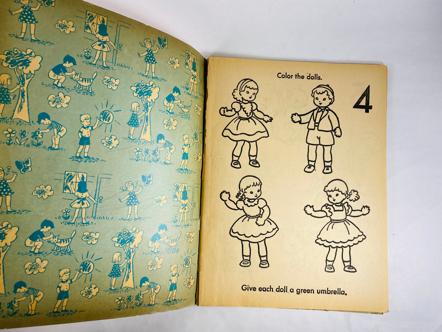 1953 Treasure Coloring Book. Vintage red activity book for children from the 1950s with some blank pages some colored. Missing Title Page