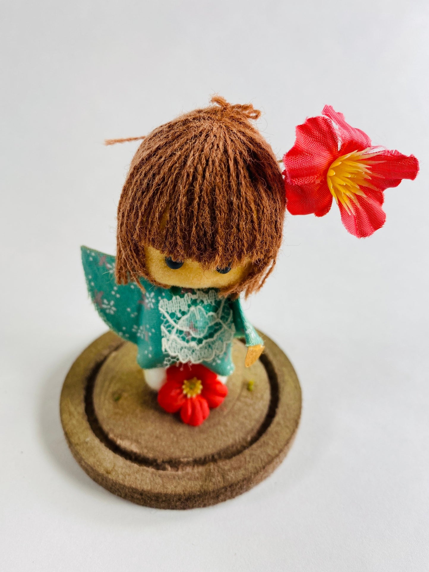 Vintage doll circa 1960s sad eyes felt girl long brown hair and pink orchid attached to round base Fisherman Aesthetic Maritime Living