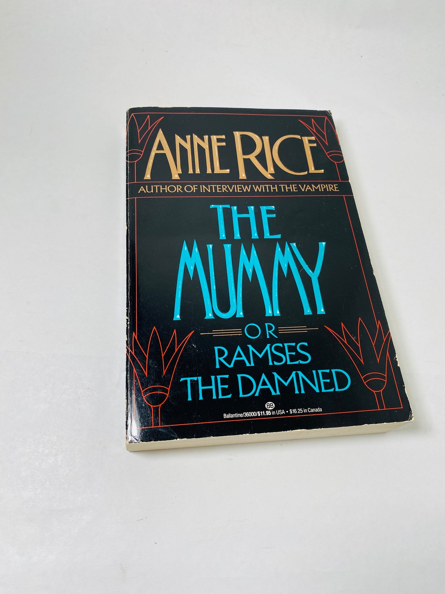 "Vintage 1989 large paperback of *The Mummy, or Ramses the Damned* by Anne Rice. Cover features an illustration of an ancient Egyptian mummy with glowing eyes. Gothic horror novel blending romance, history, and the supernatural."