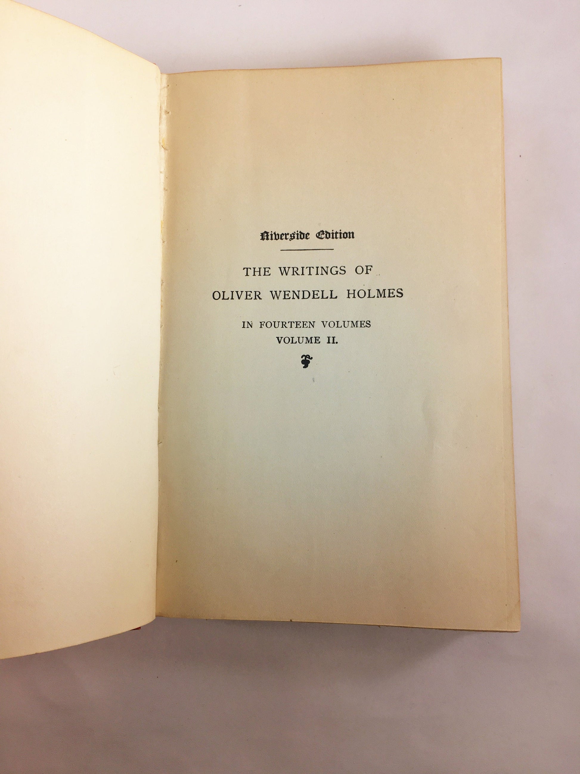 1892 Oliver Wendell Holmes The Autocrat Professor at the Breakfast Table. Vintage red book of a collection of essays. Decor prop staging