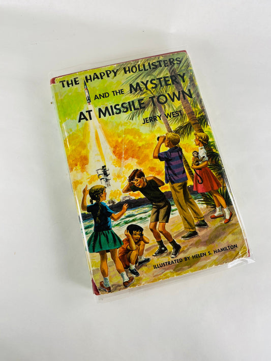 1961 Happy Hollisters and the Mystery at Missile Town. Vintage book by Jerry West with dust jacket. Cloth Bound Mystery Stories