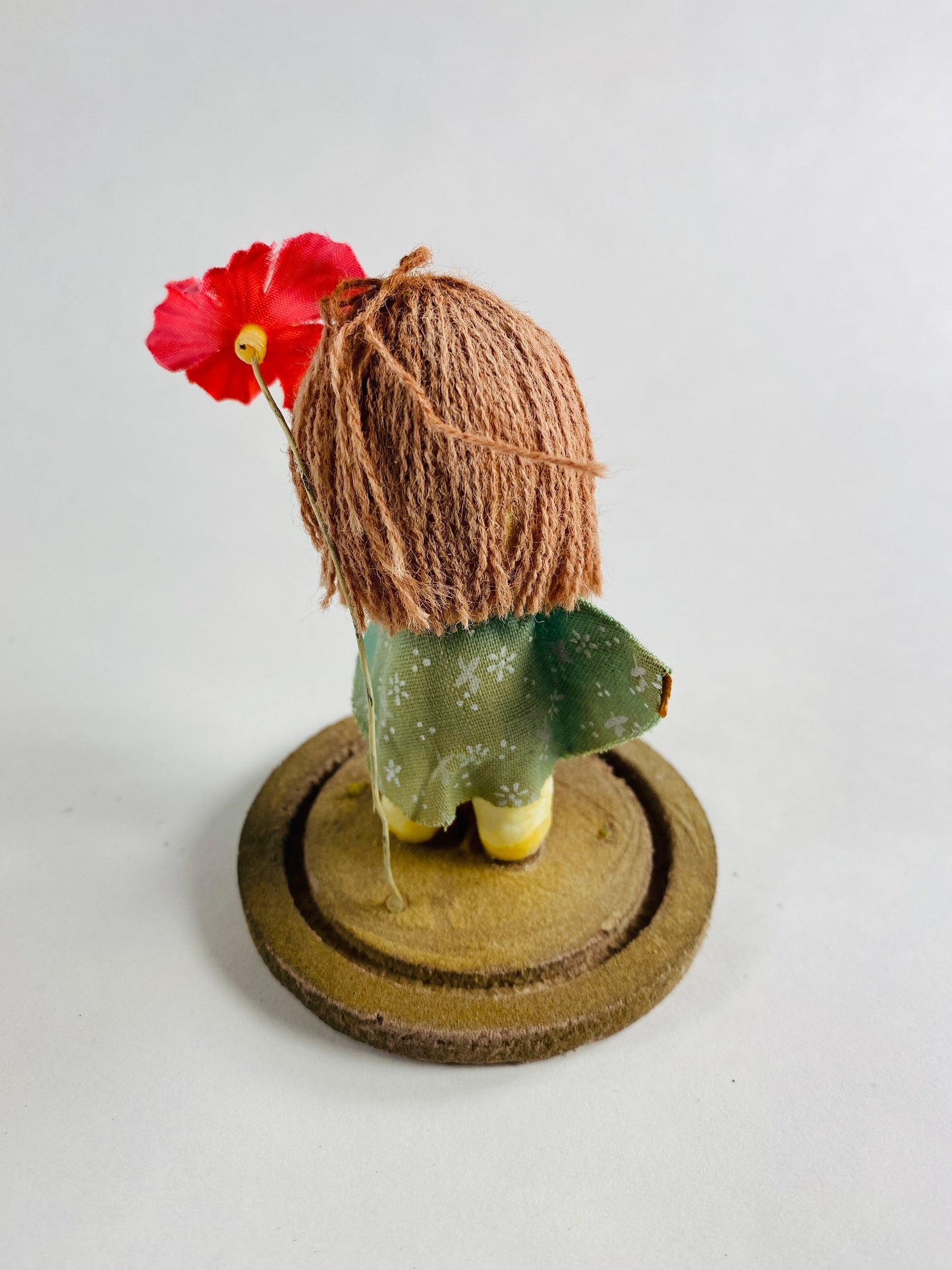 Vintage doll circa 1960s sad eyes felt girl long brown hair and pink orchid attached to round base Fisherman Aesthetic Maritime Living
