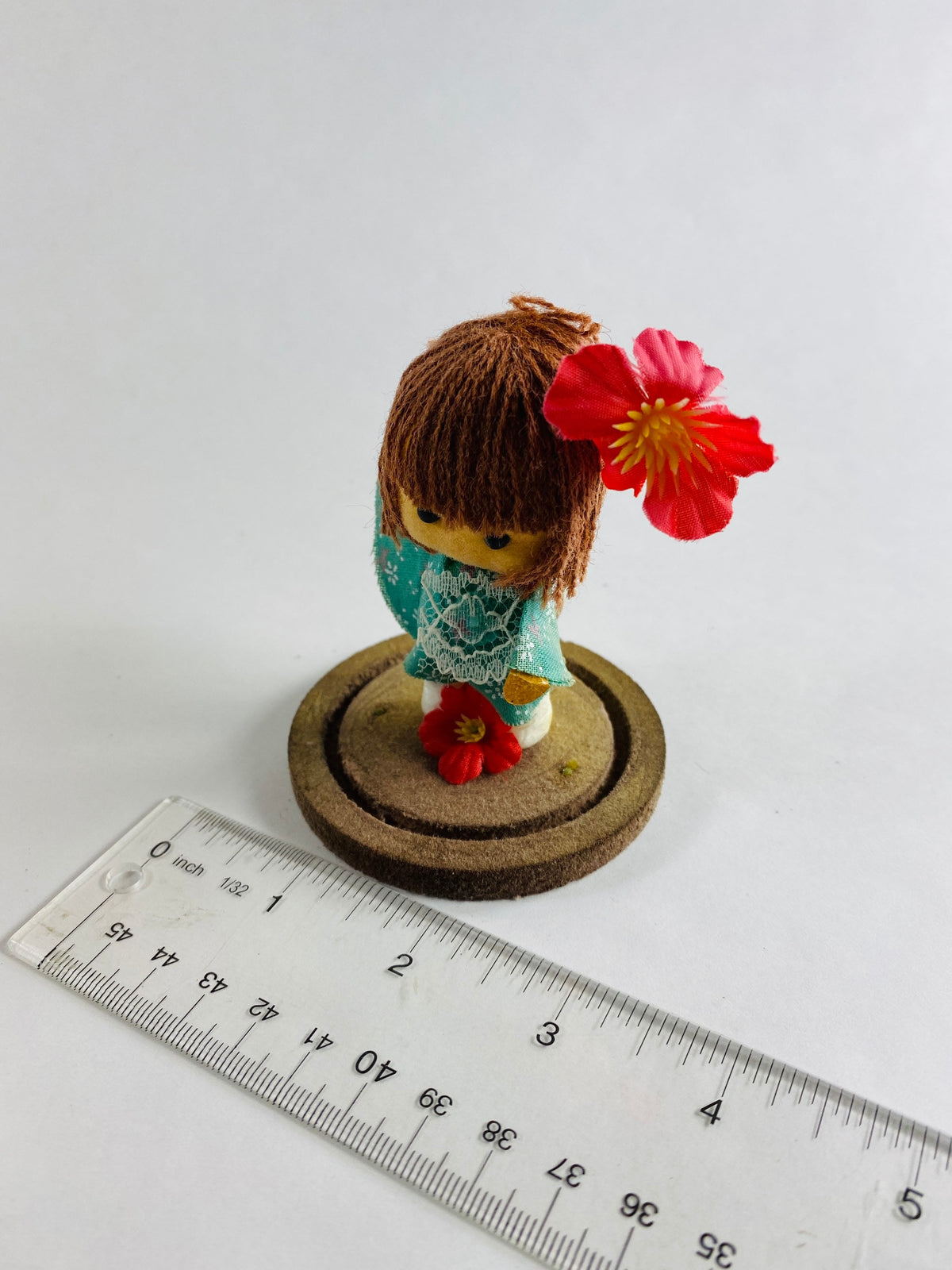 Vintage doll circa 1960s sad eyes felt girl long brown hair and pink orchid attached to round base Fisherman Aesthetic Maritime Living