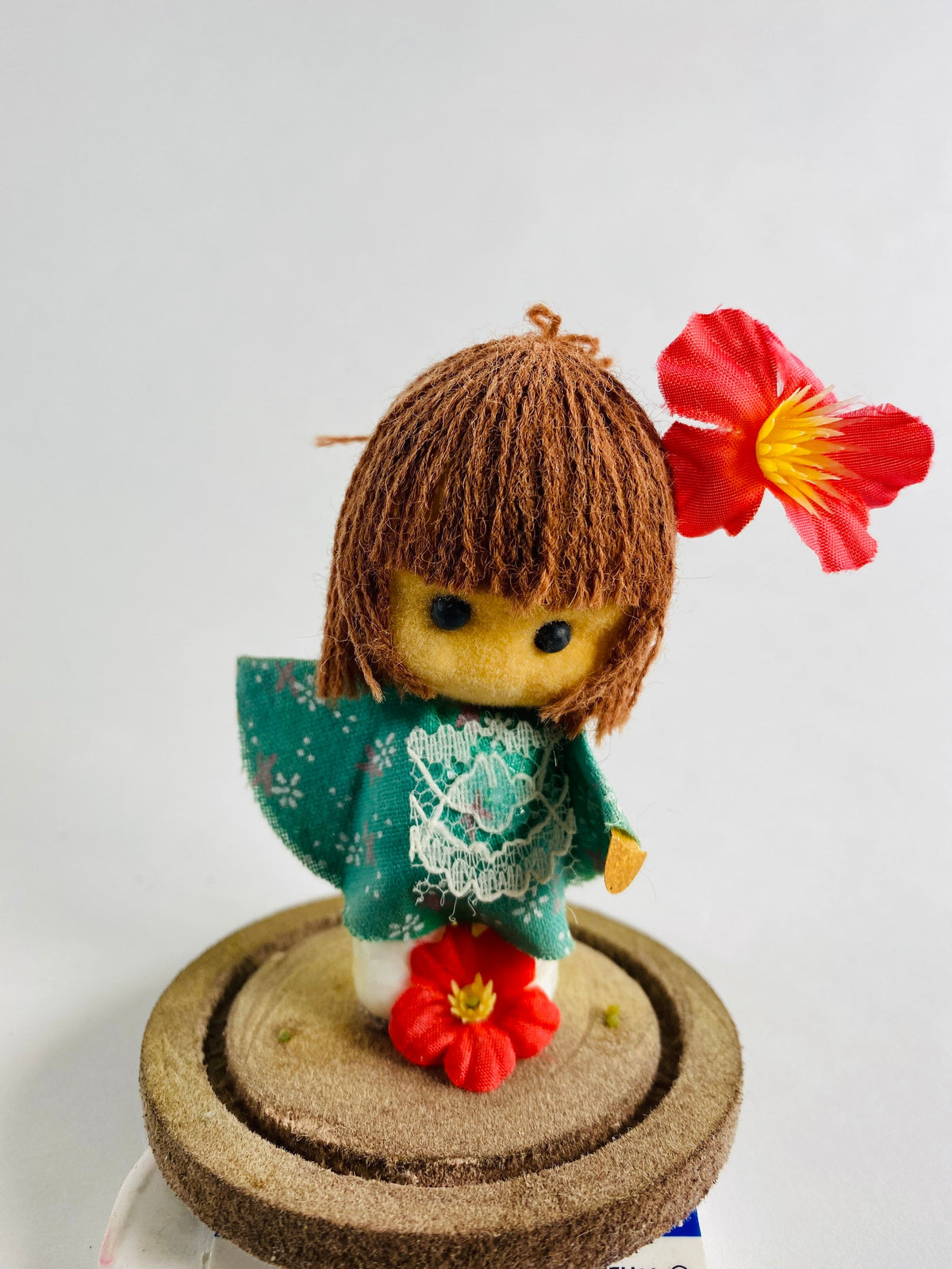 Vintage doll circa 1960s sad eyes felt girl long brown hair and pink orchid attached to round base Fisherman Aesthetic Maritime Living
