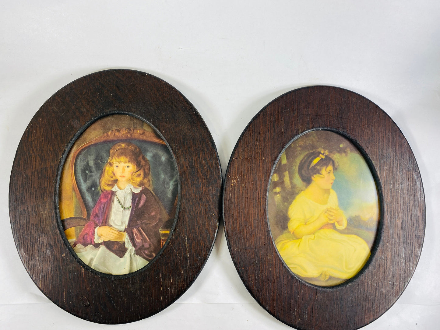 Gothic vintage wood framed haunting portraits circa 1960 with images of young girls of Victorian era home decor display. VC Andrews art