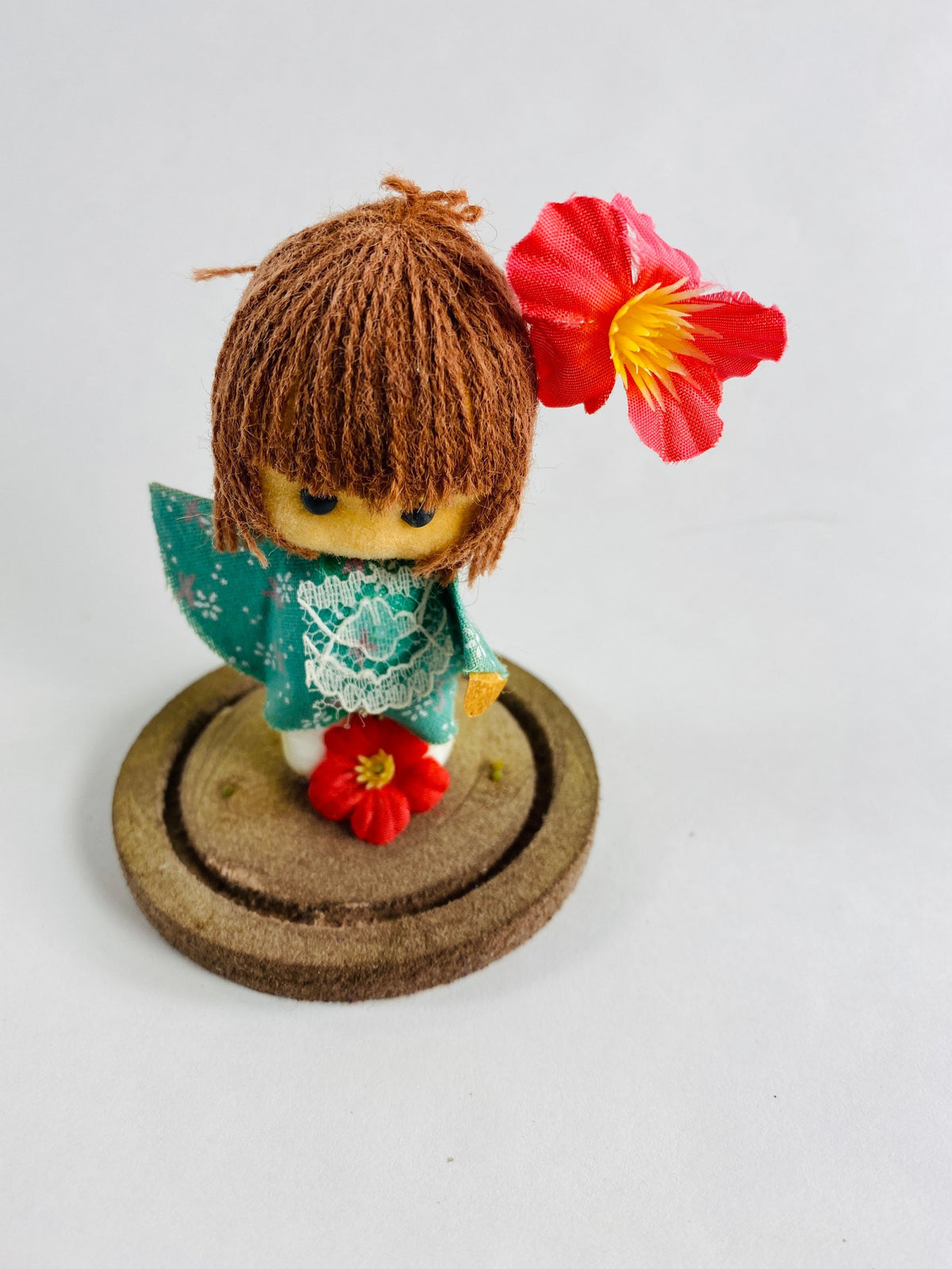 Vintage doll circa 1960s sad eyes felt girl long brown hair and pink orchid attached to round base Fisherman Aesthetic Maritime Living