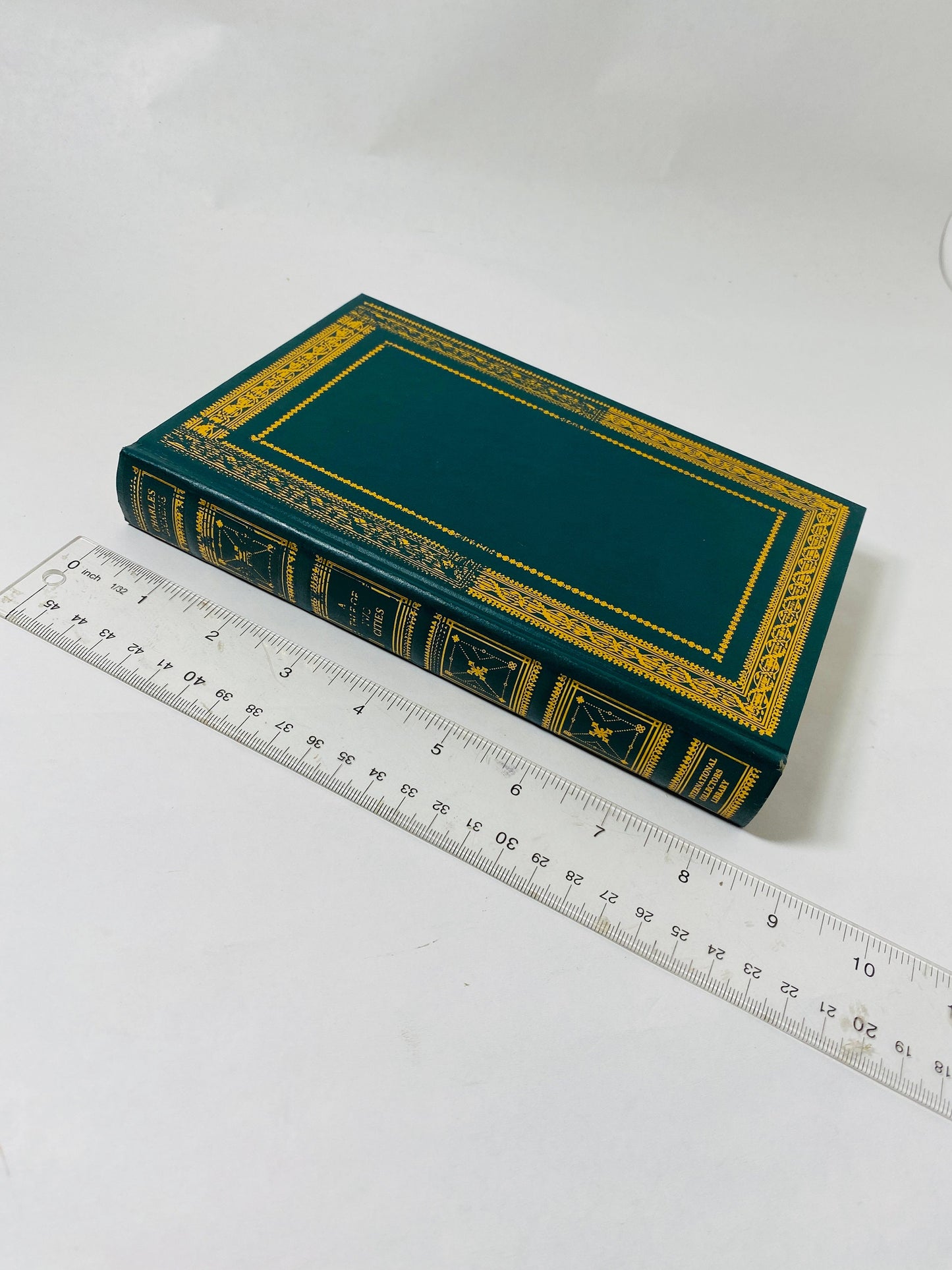 A Tale of Two Cities by Charles Dickens vintage green book with gold gilt lettering. French Revolution.