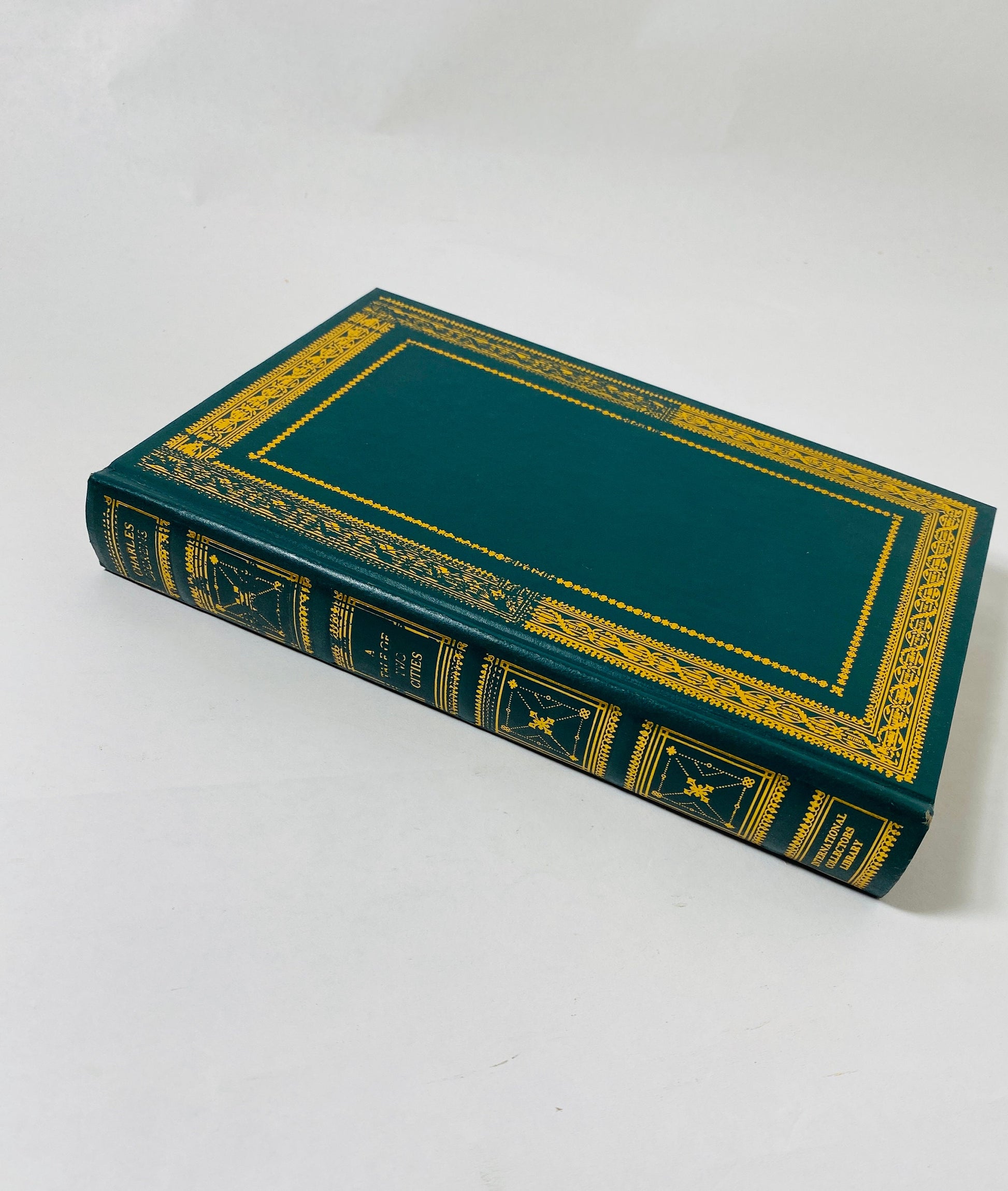 A Tale of Two Cities by Charles Dickens vintage green book with gold gilt lettering. French Revolution.