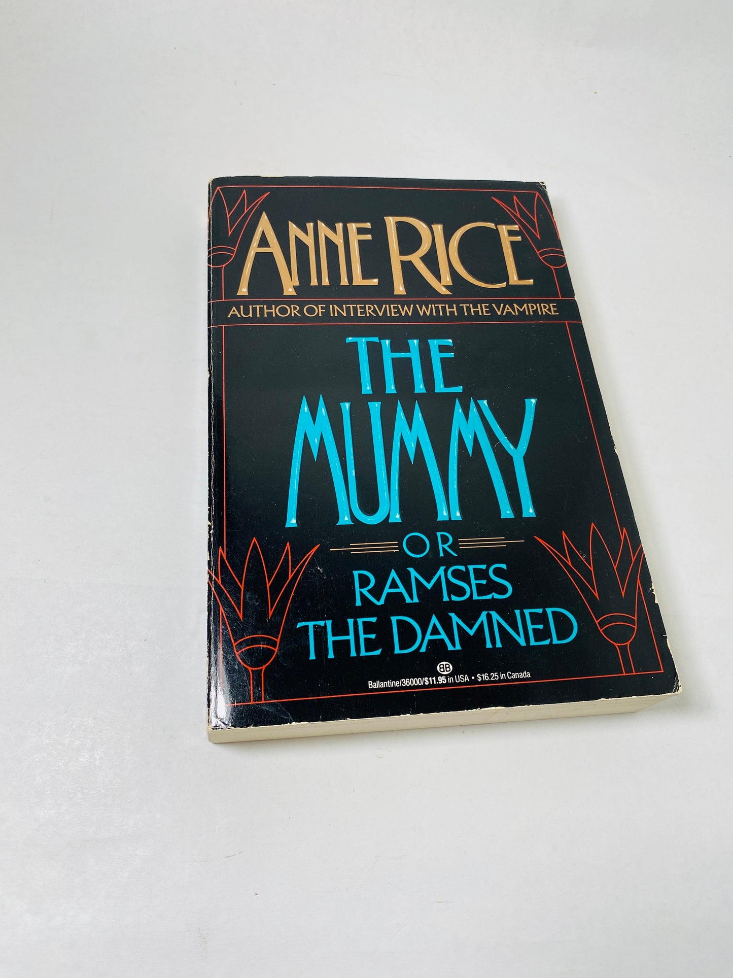 "Vintage 1989 large paperback of *The Mummy, or Ramses the Damned* by Anne Rice. Cover features an illustration of an ancient Egyptian mummy with glowing eyes. Gothic horror novel blending romance, history, and the supernatural."