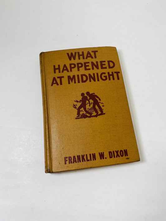 1931 vintage edition of What Happened at Midnight by Franklin W. Dixon. Brown cover featuring classic Hardy Boys artwork. This collectible follows Frank and Joe Hardy as they solve a thrilling mystery, perfect for young readers and collectors.