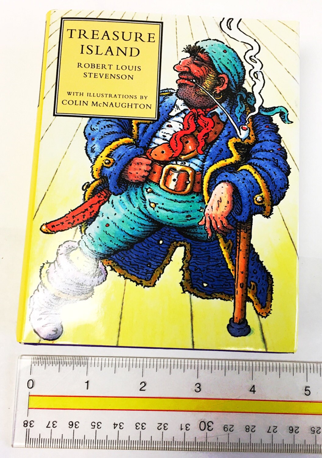 Vintage Treasure Island book by Robert Louis Stevenson. Coming-of-age story. Long John Silver. Pirates fiction