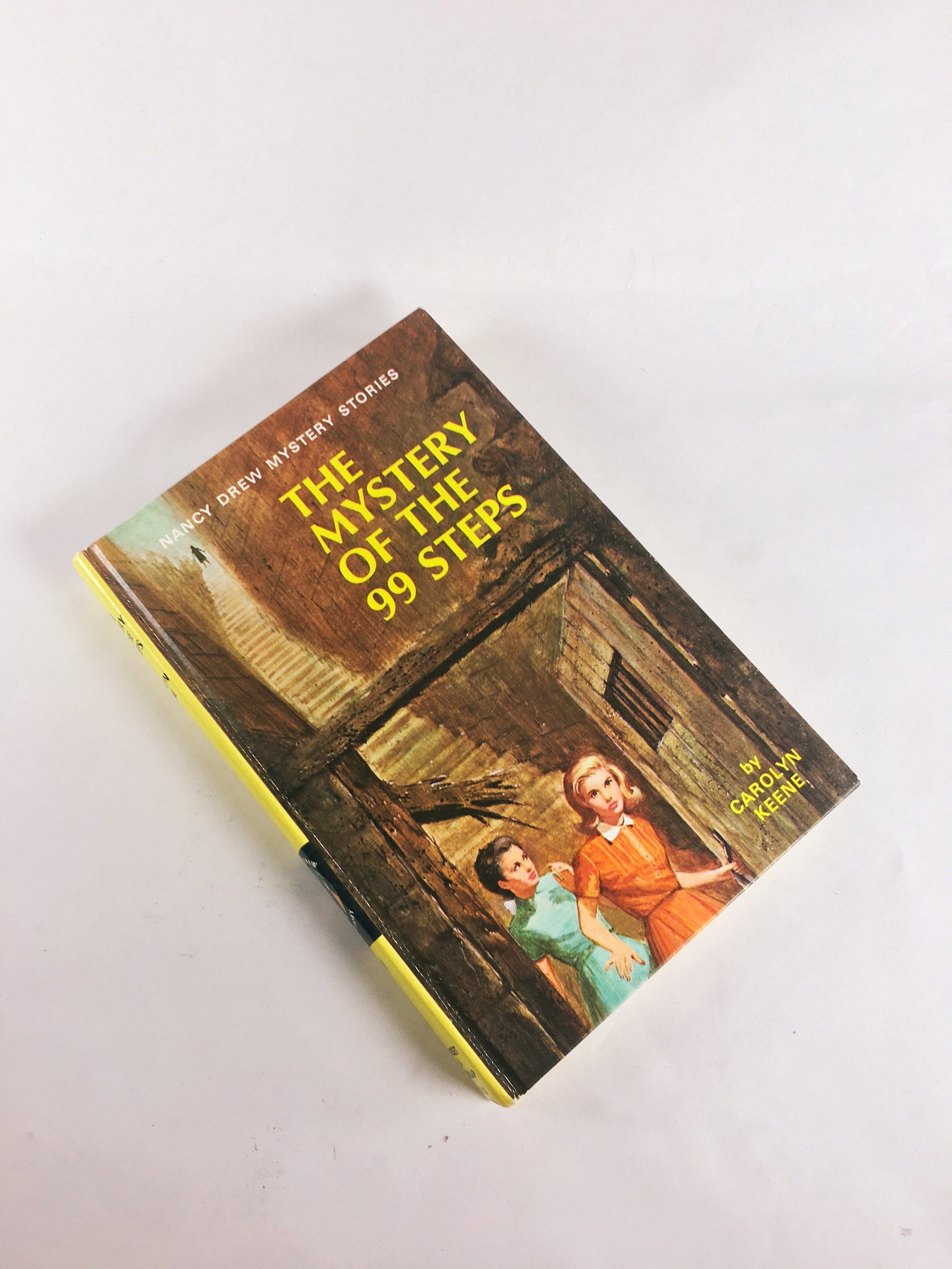Nancy Drew Mystery Stories 1960s 1970 by Carolyn Keene. Vintage picture cover books with black & white endpapers. Teen tween reading yellow